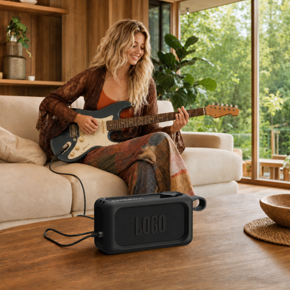 JBL BandBox Solo speaker in black silicone case beside a guitarist