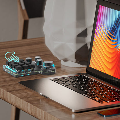 12-key 4-knob mini keyboard used beside a laptop