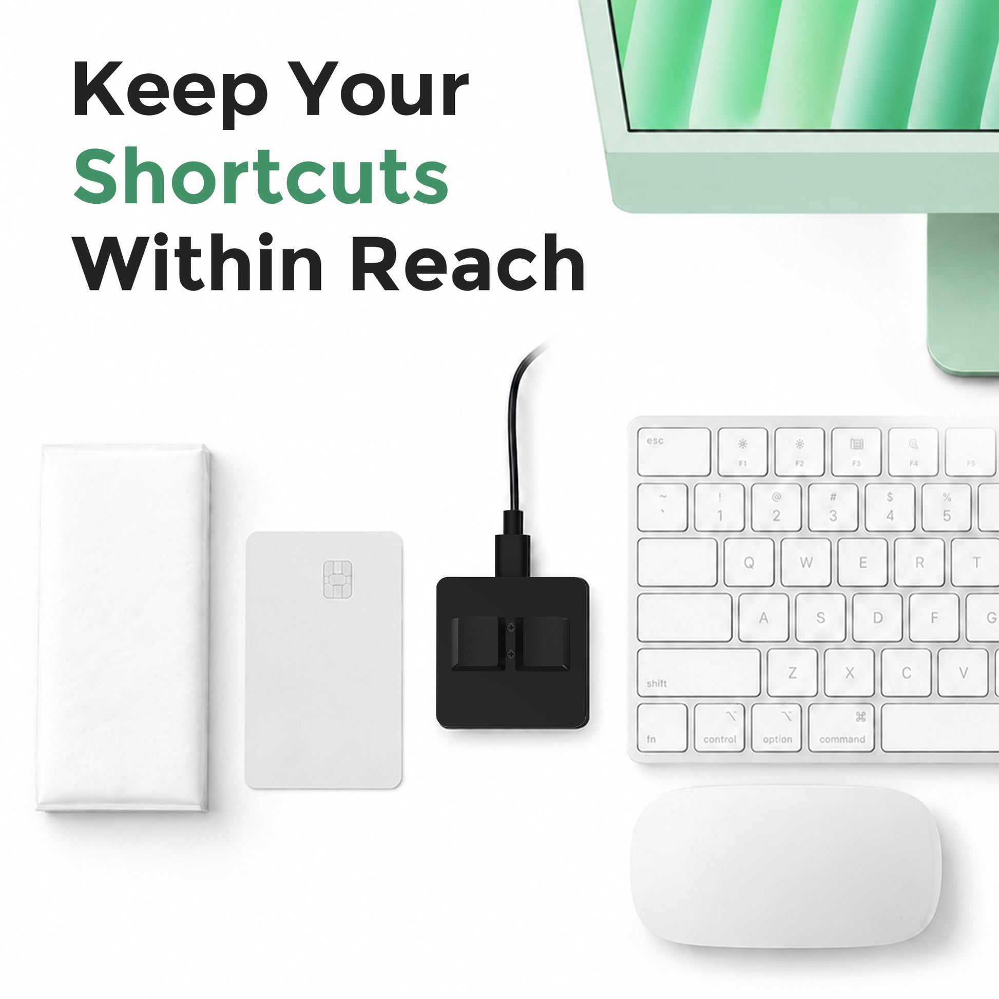Compact 2-key macro keypad beside desktop accessories